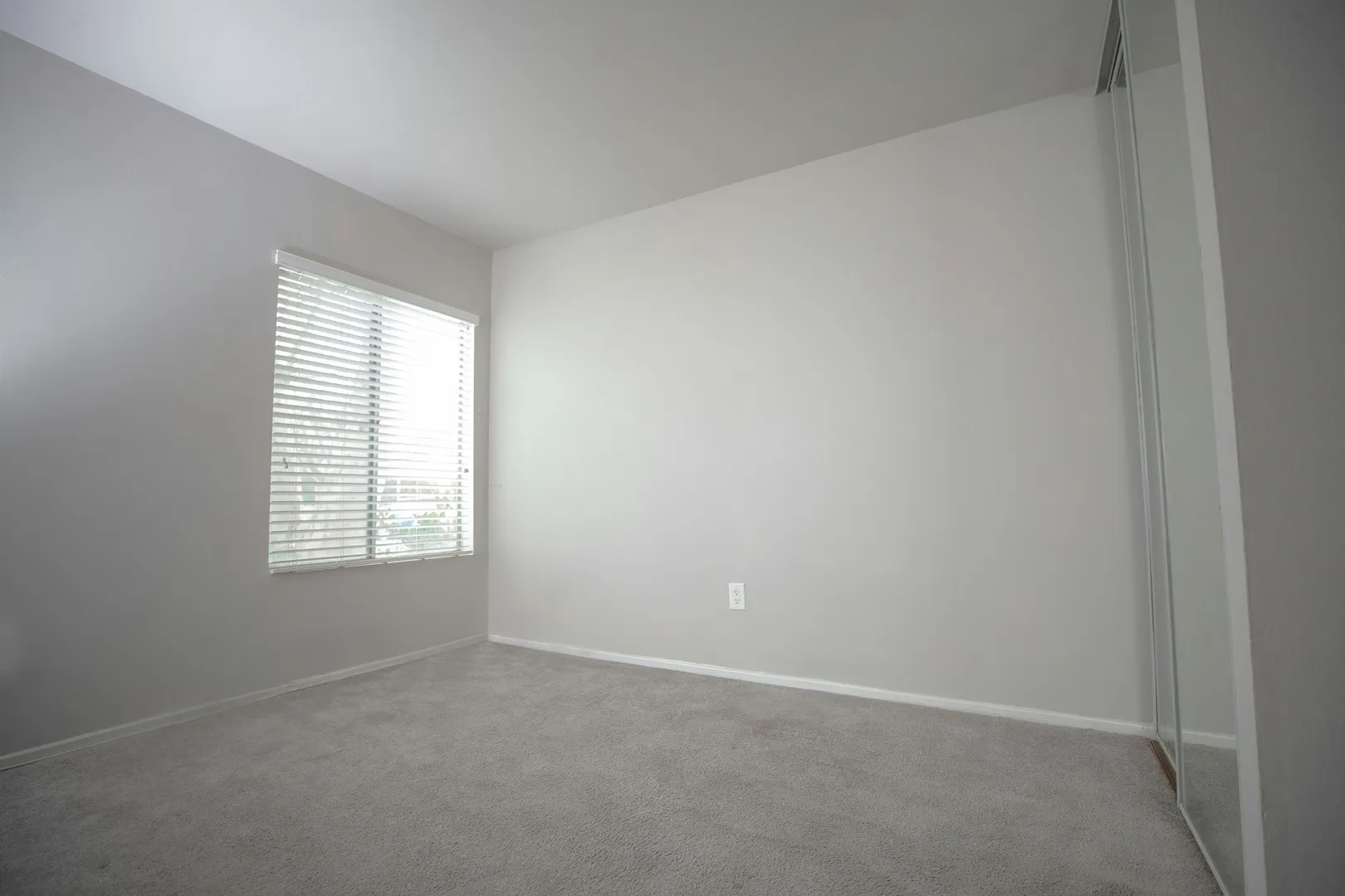 Before: Virtual staging software furnishing a spare room